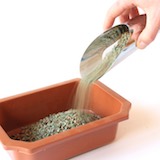 Get started by applying a layer of a coarse, water draining substrate, like lava rock or grit.
